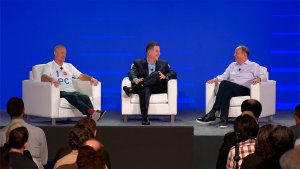 Dell executives Jeff Clarke, Michael Dell, and Sam Burd interact on stage during Dell's CES AI PC announcement