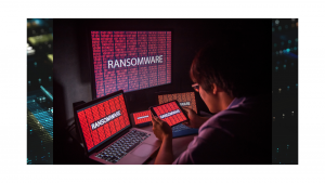 SecurityANGLE webcast on cybersecurity, image of hacker sitting in front of monitors